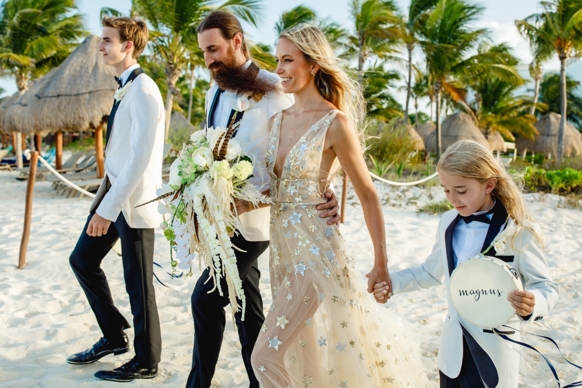 Happy wedding couple and family on a beautiful tropical beach