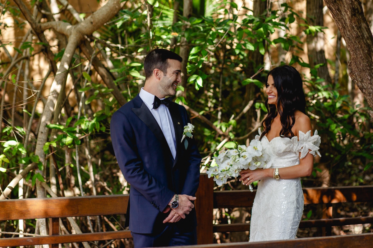 Bride and groom smiling at outdoor wedding ceremony