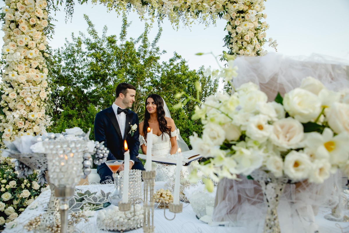 Bride and groom at flower decorated wedding ceremony