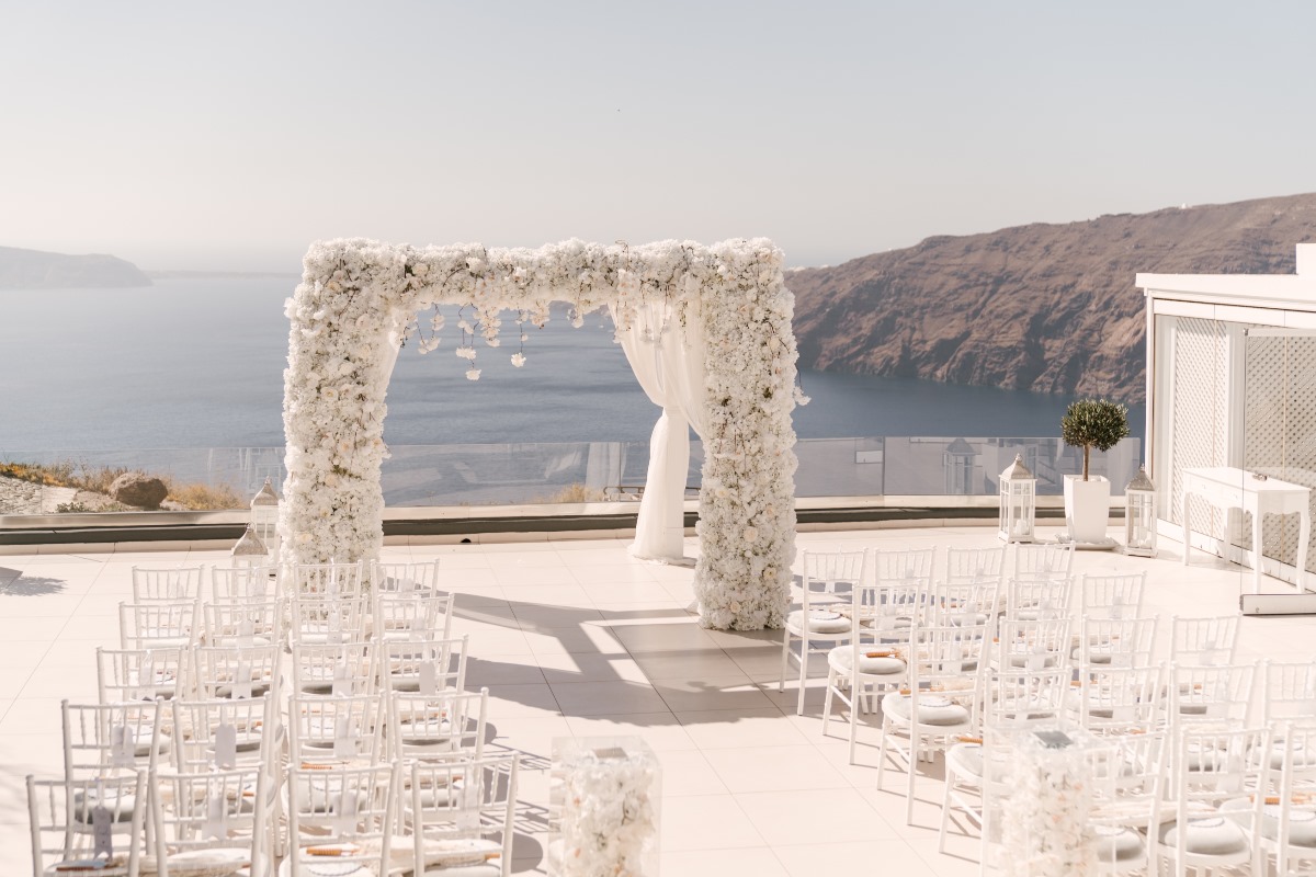 Santorini wedding venue with floral arch and sea view