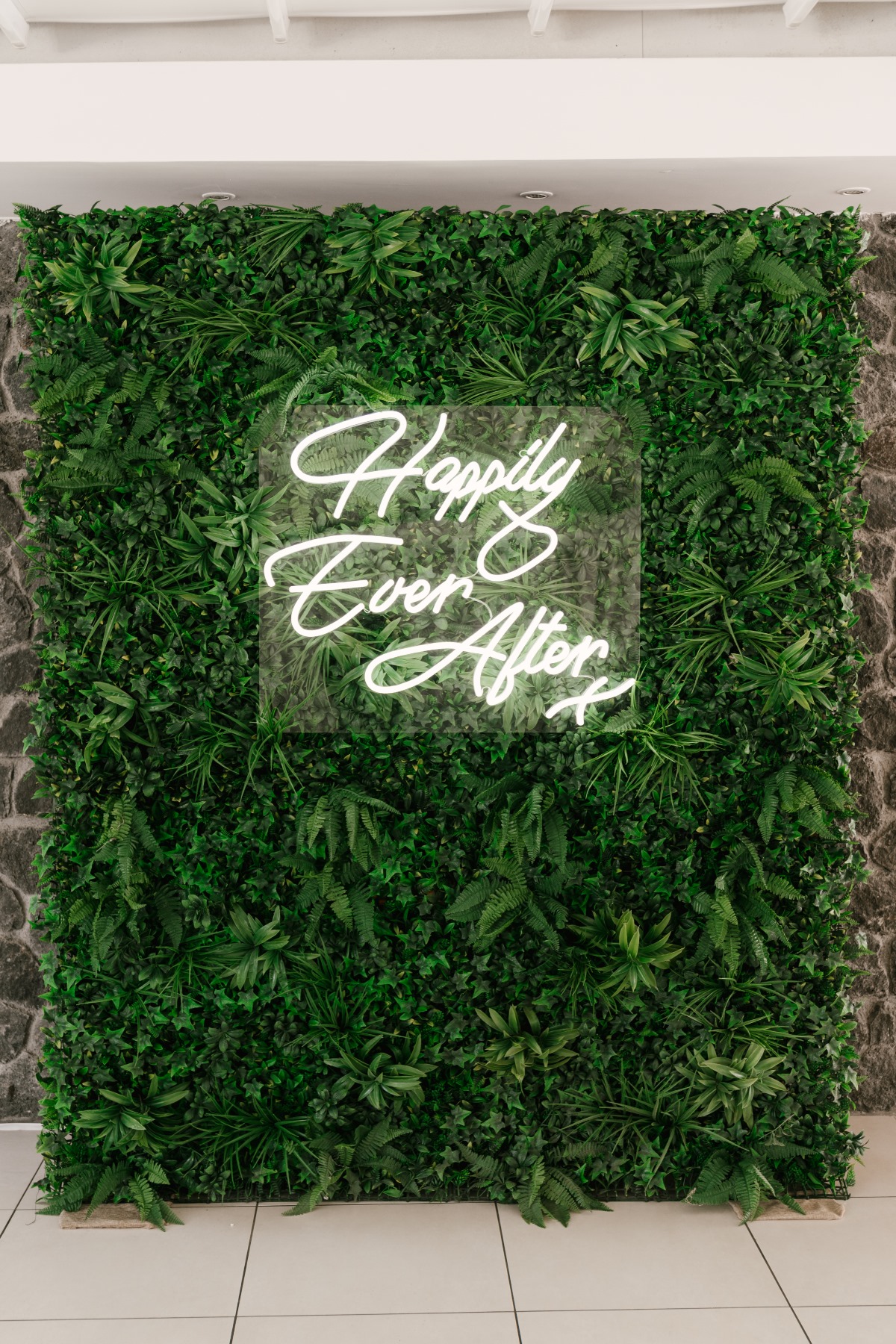 Green wall with a neon sign reading Happily Ever After