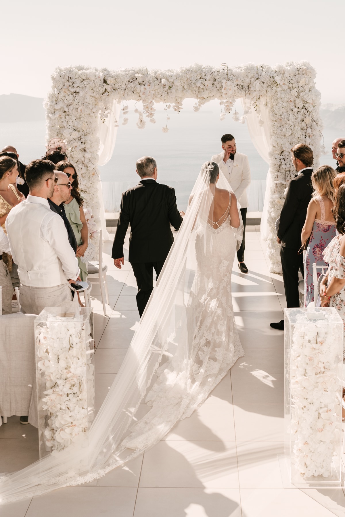 Bride walking down aisle towards groom at wedding ceremony