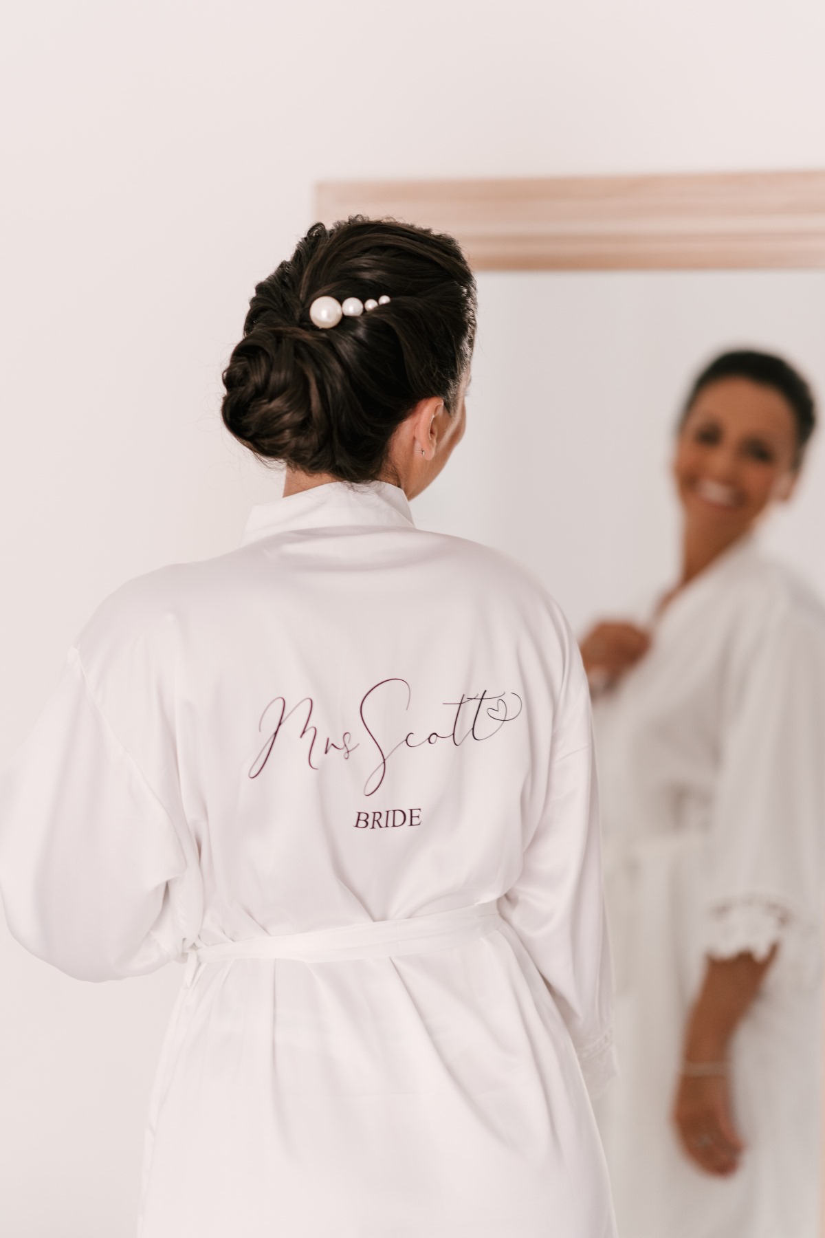 Bride wearing robe with Mrs Scott Bride on the back