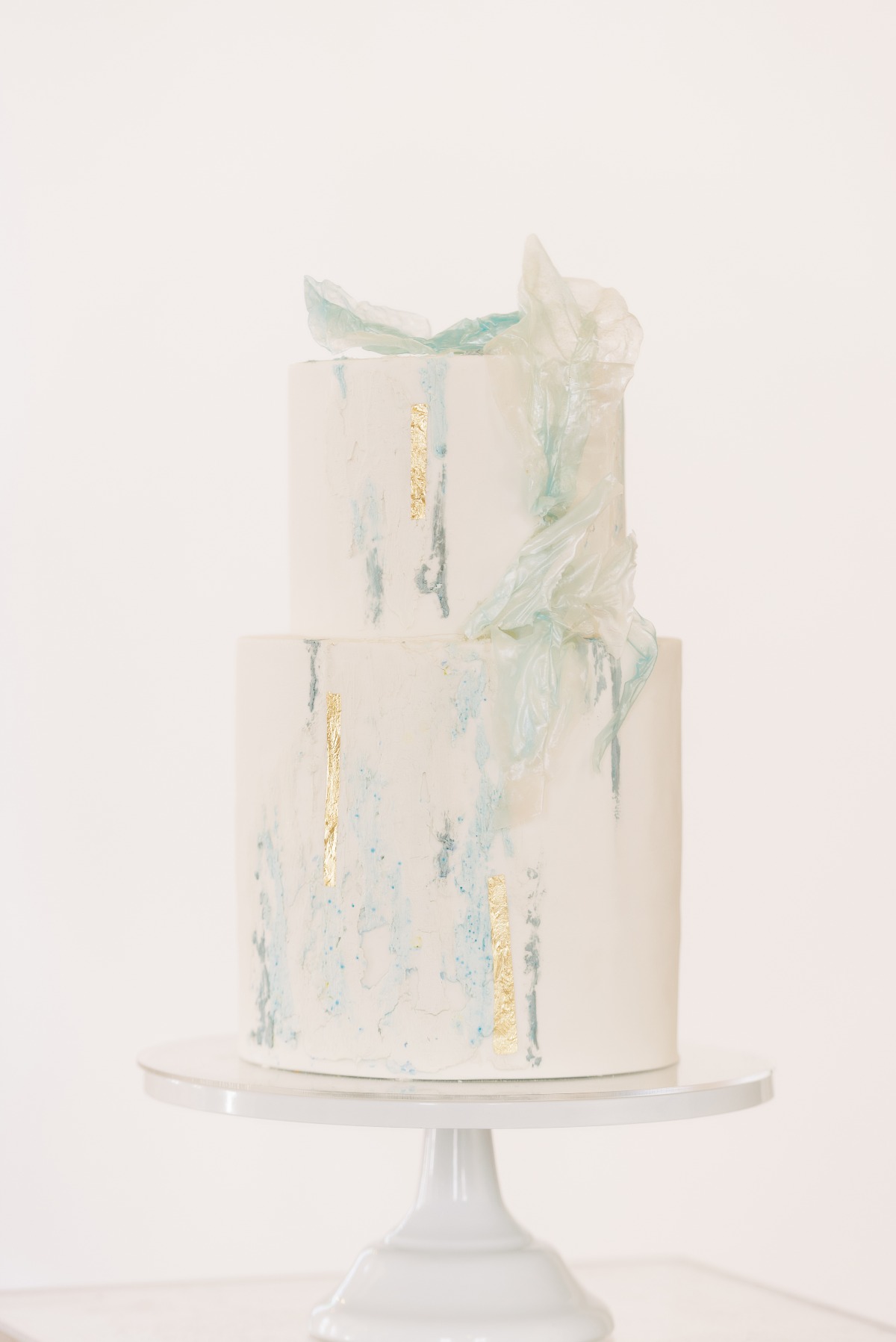 Elegant two tier wedding cake with gold and blue details