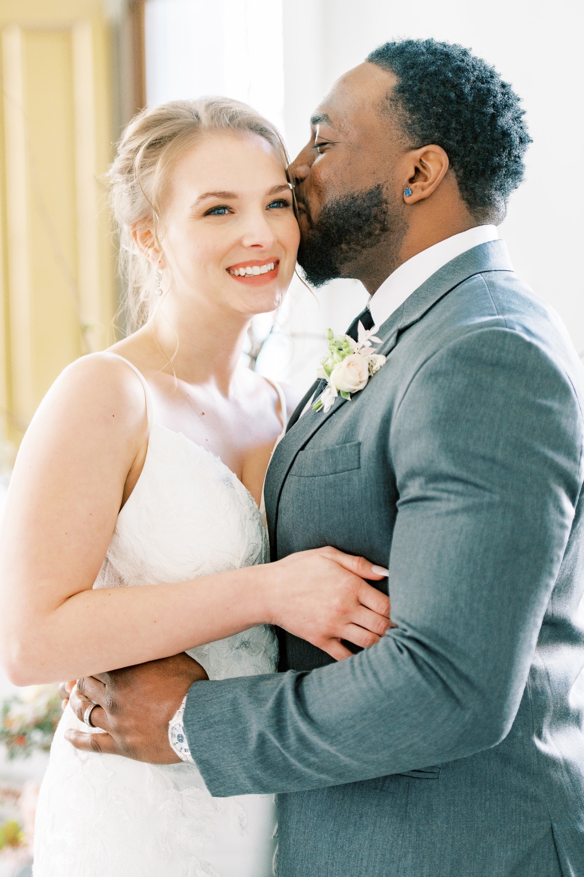 Happy groom kissing his beautiful bride on their wedding day