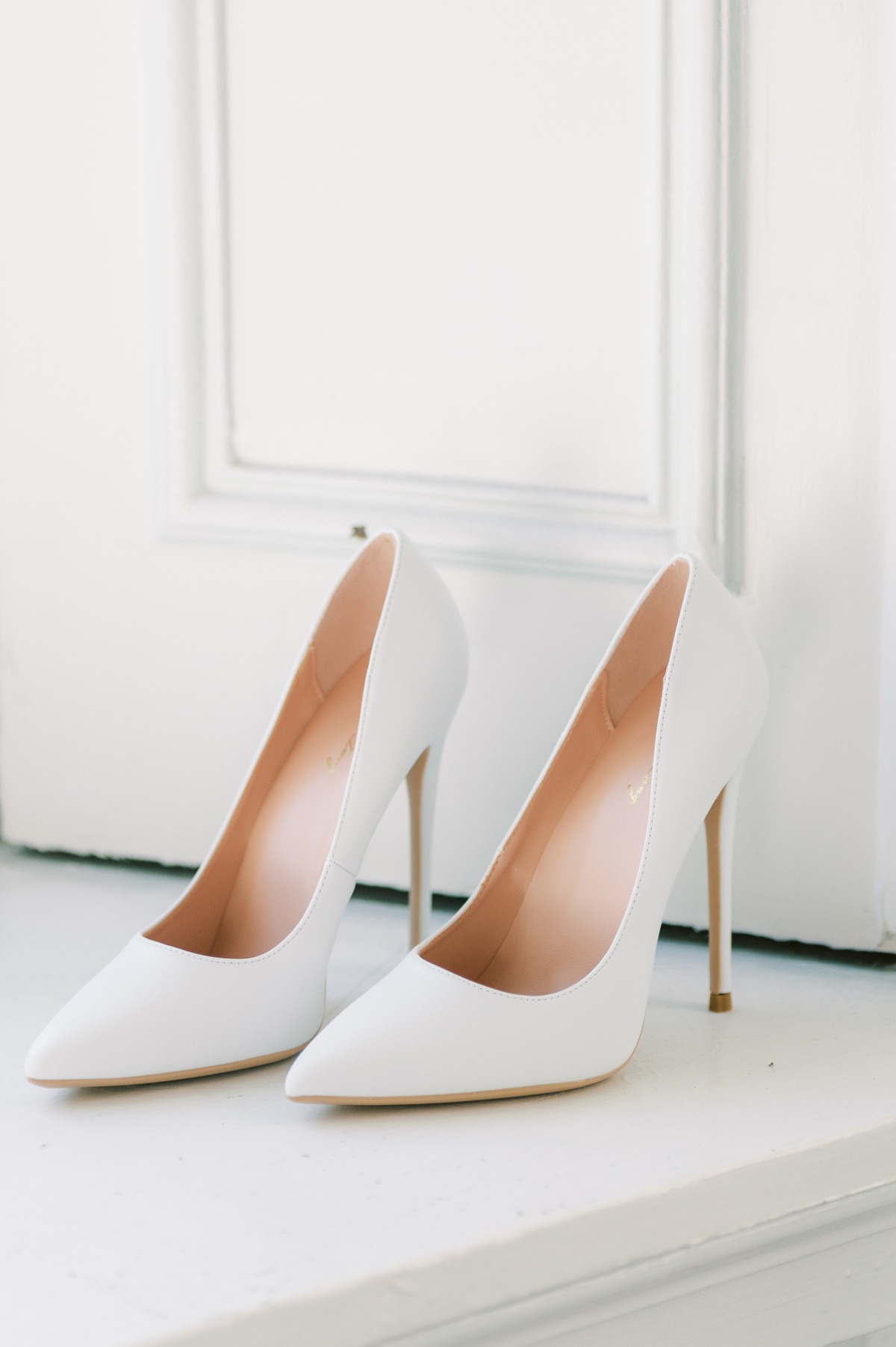 Elegant white pointed toe high heels for a stylish bride
