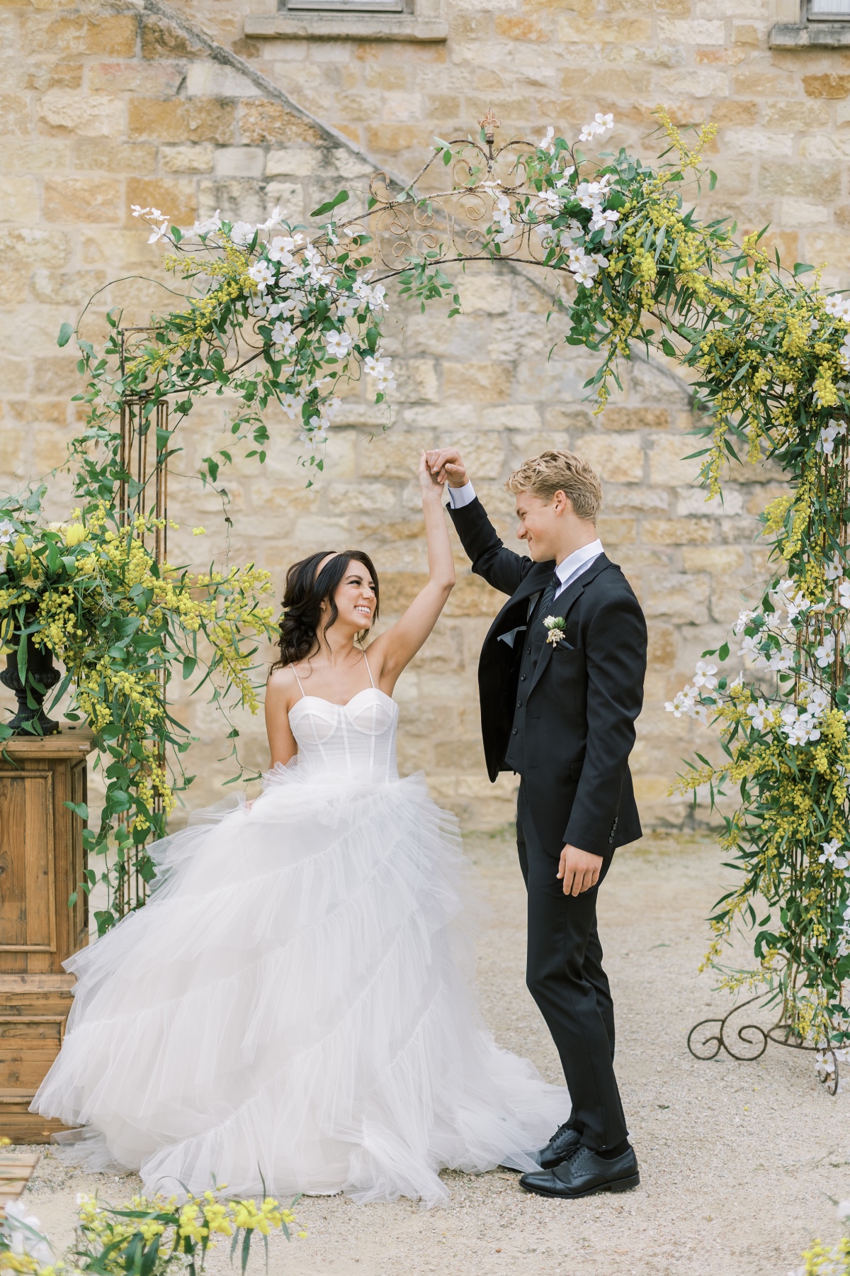 Bride and groom share first dance at outdoor wedding venue