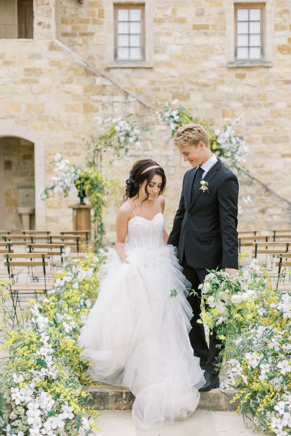 Bride and groom descend stairs at their beautiful outdoor wedding