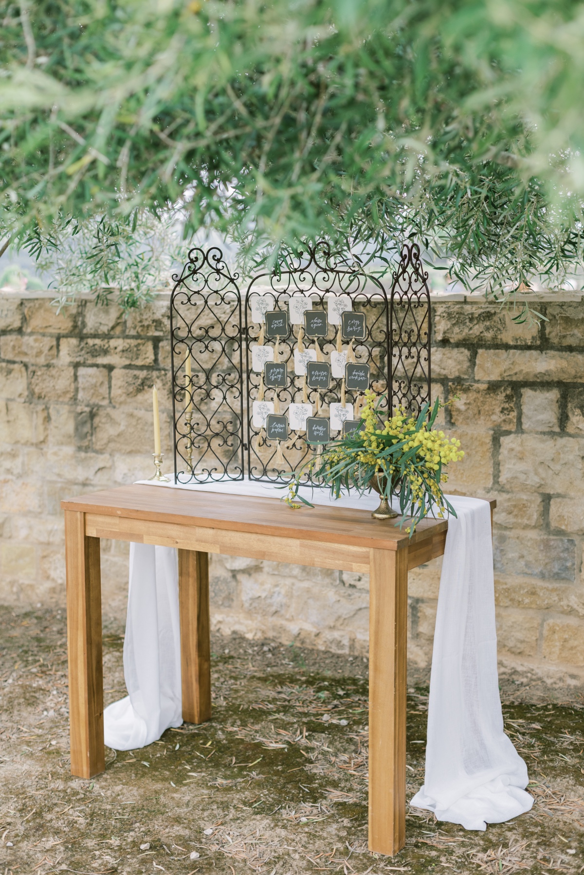 Rustic wedding table with wrought iron seating chart display