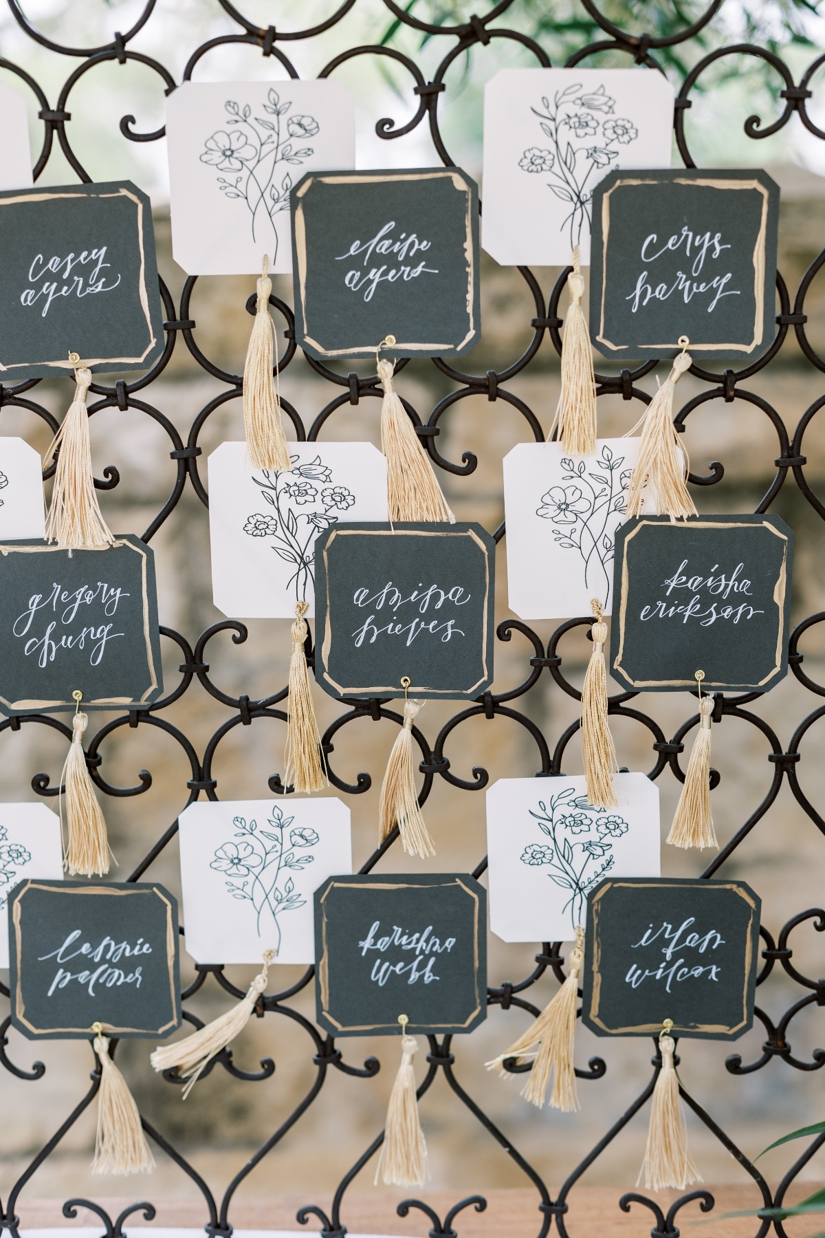 Elegant wedding seating chart with calligraphy and tassels