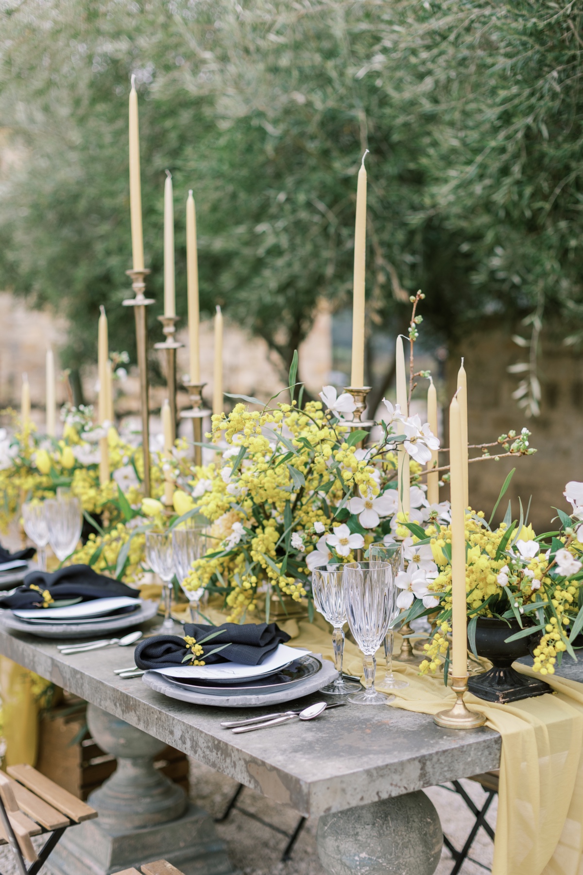 Elegant wedding table setting with yellow flowers candles