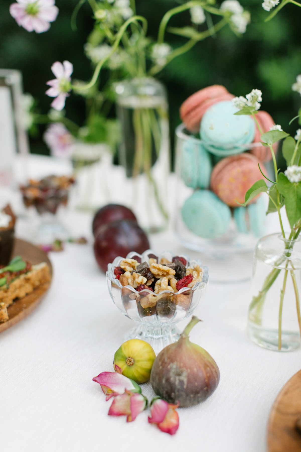 Beautiful table setting with figs, macarons, and flowers