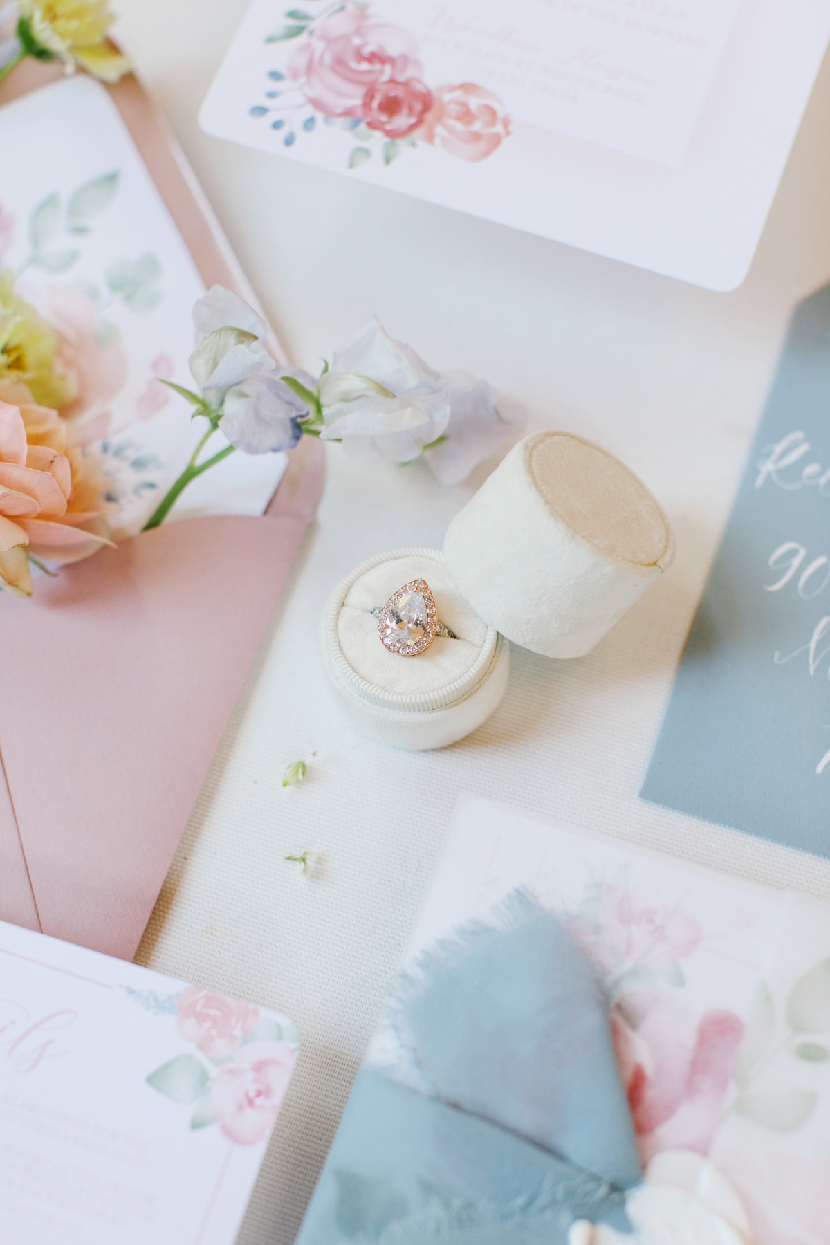Elegant engagement ring with floral wedding stationery details