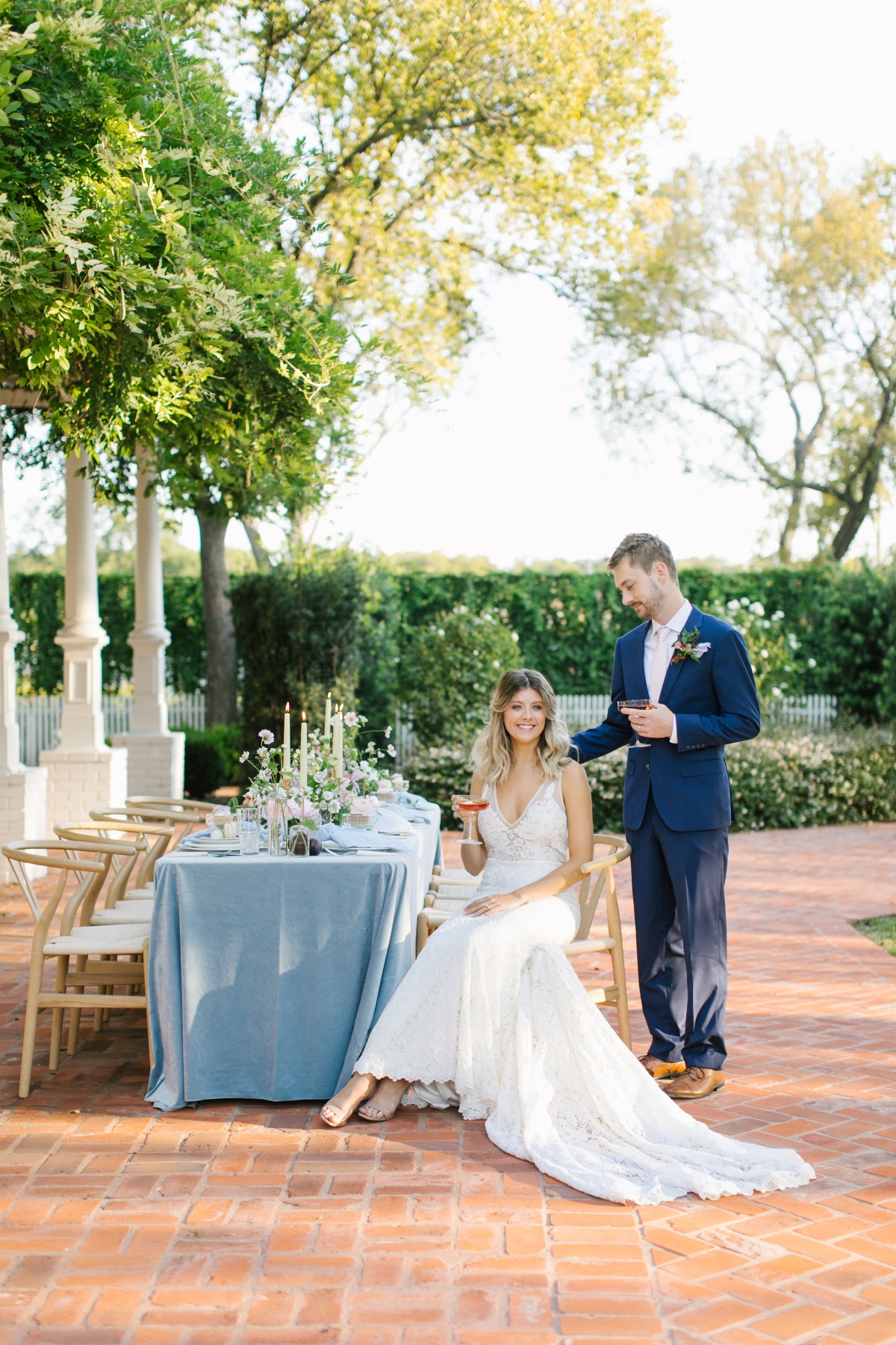 Bride and groom celebrate their wedding with drinks outside