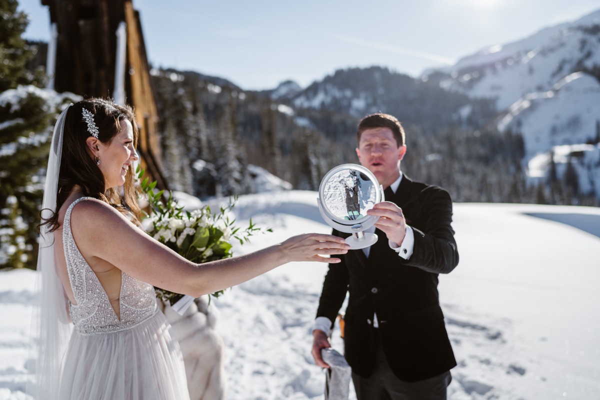 Bride and groom looking at reflection in mirror, wedding day in winter