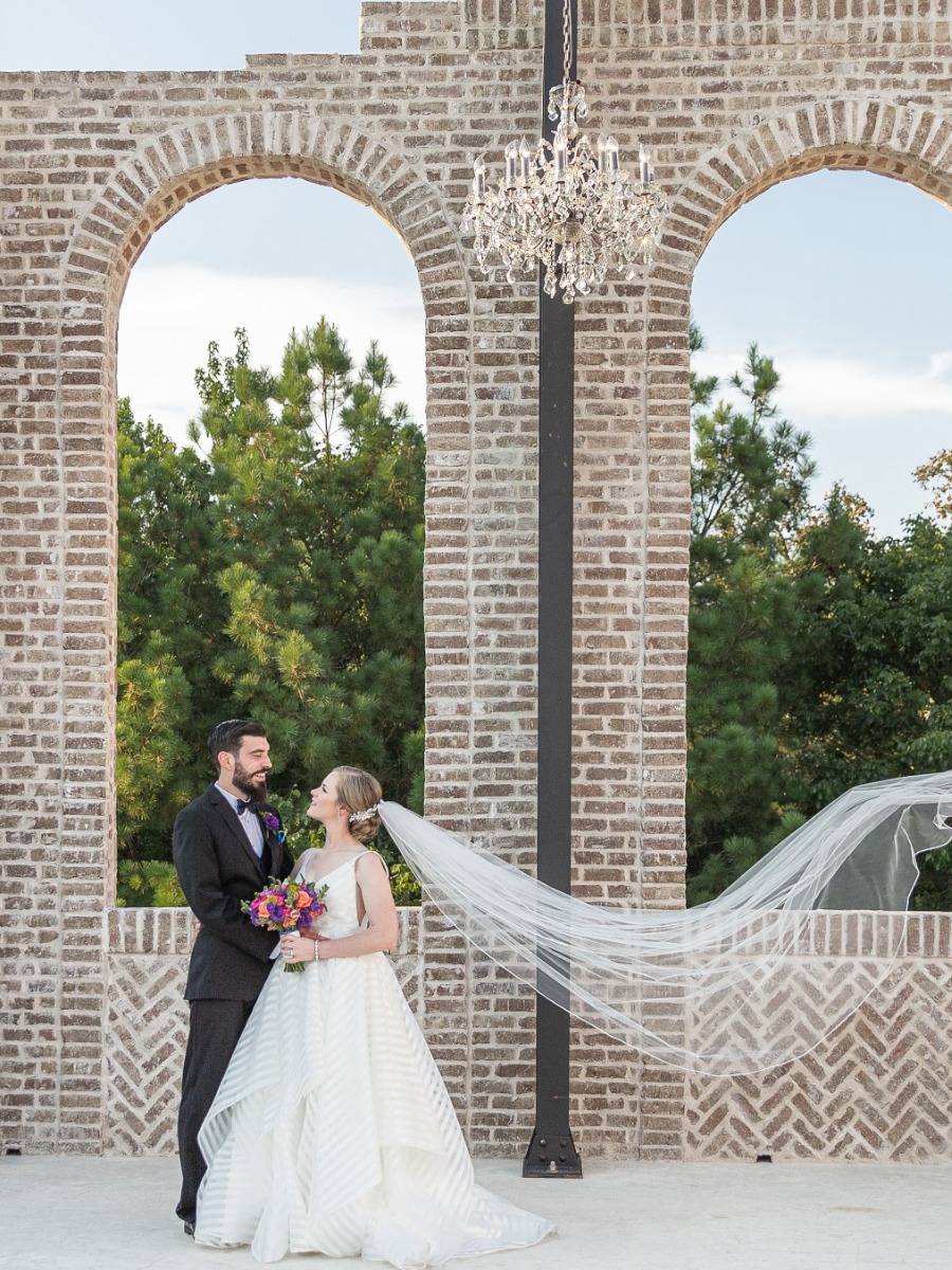 A Tuscan Inspired Wedding Venue With Bright Florals and Two Cakes