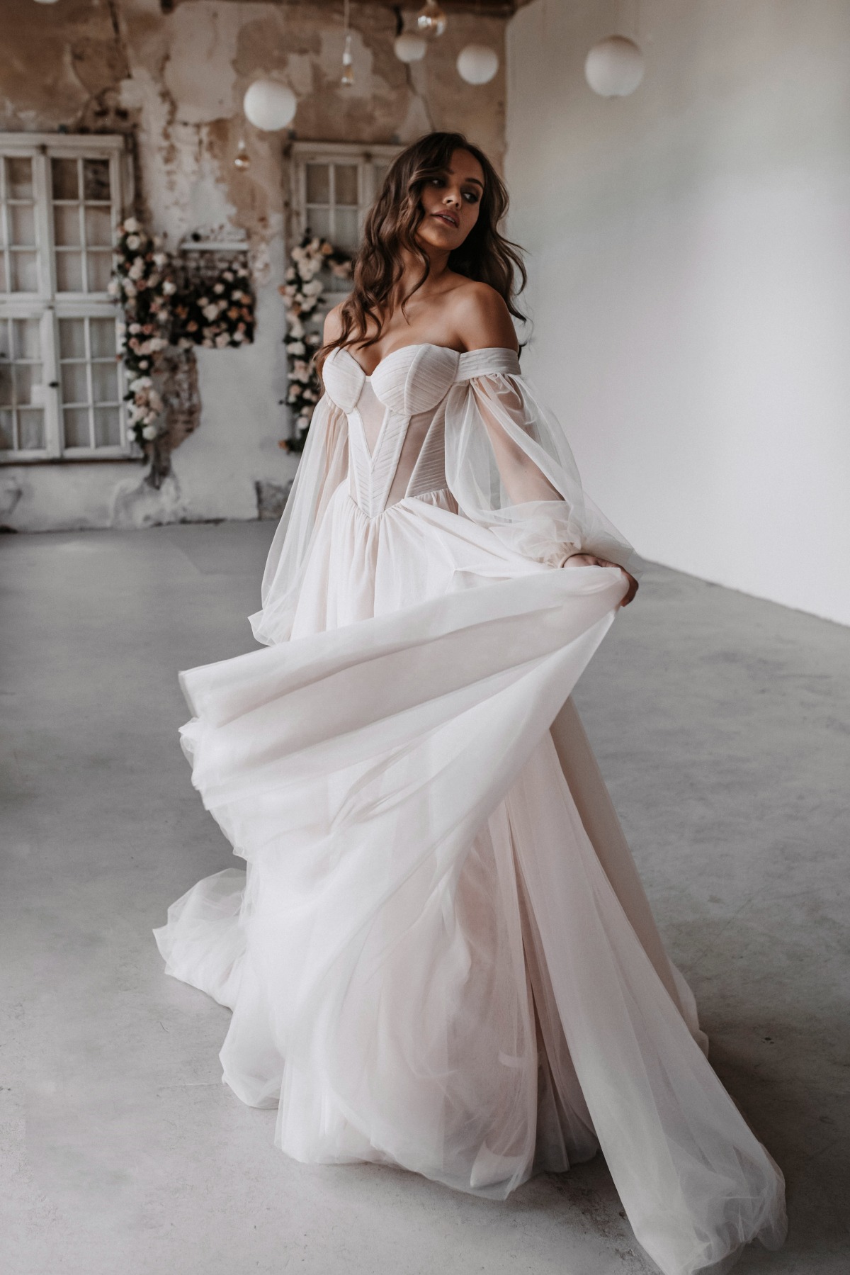 Elegant bride in a flowing off-the-shoulder wedding dress