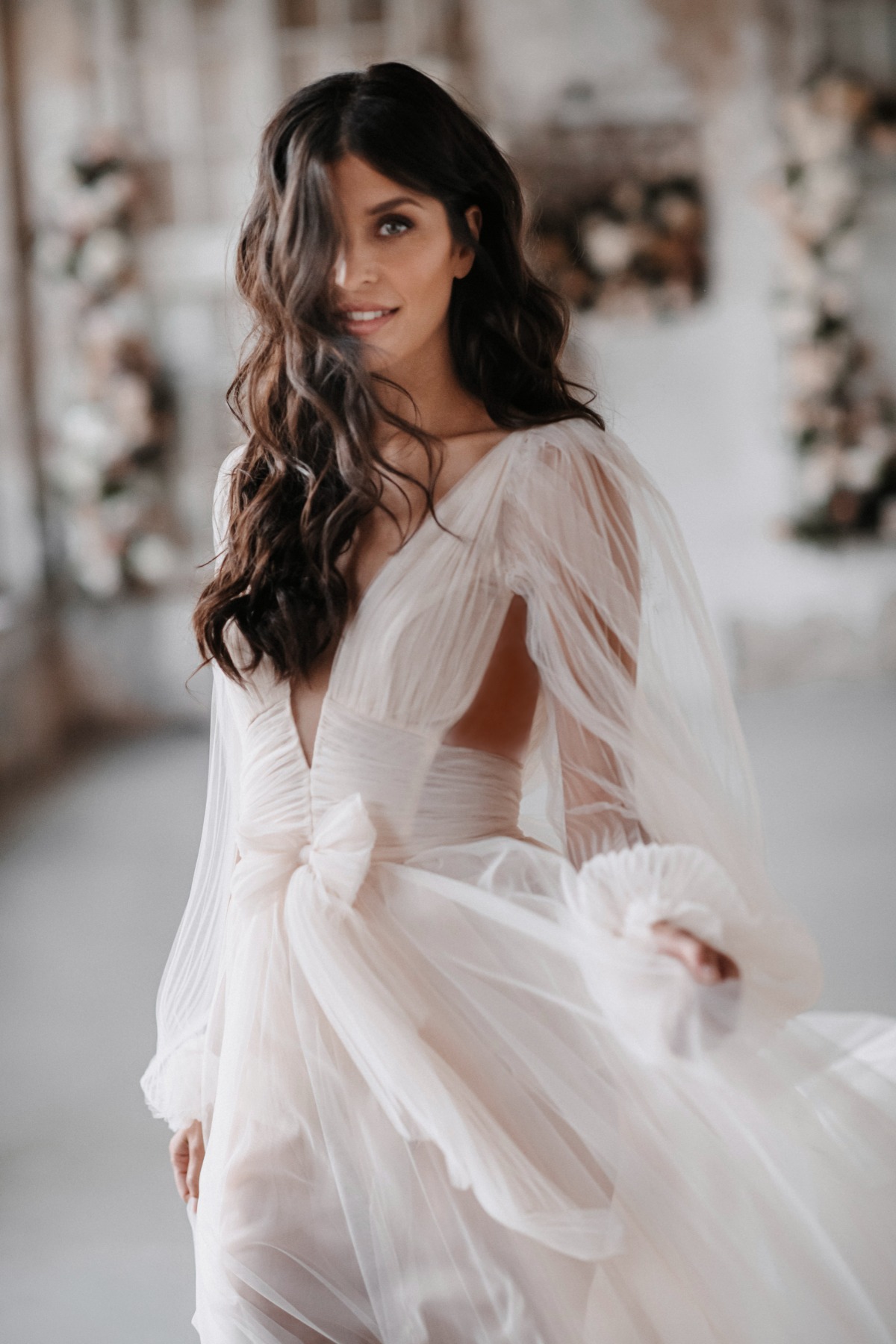 Beautiful woman in flowing wedding dress smiling softly