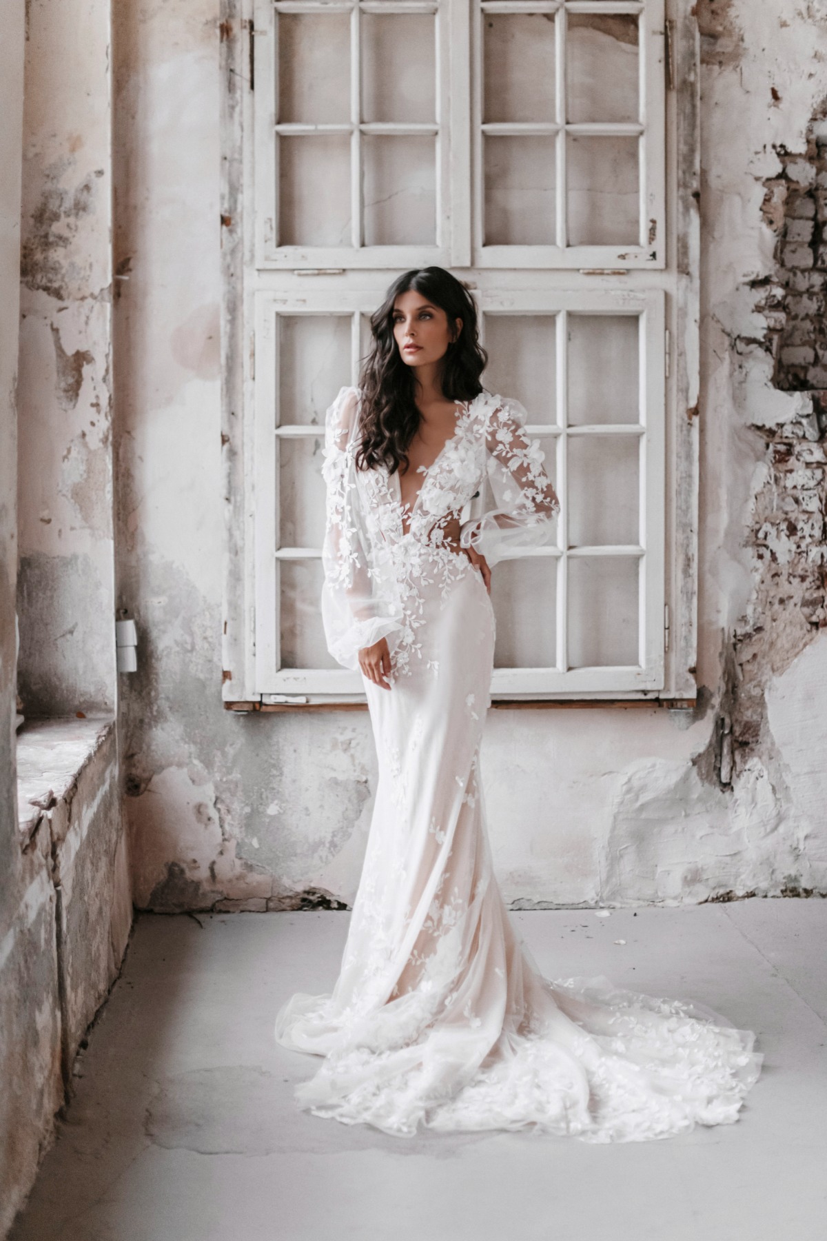 Elegant bride in a beautiful white wedding dress with floral details