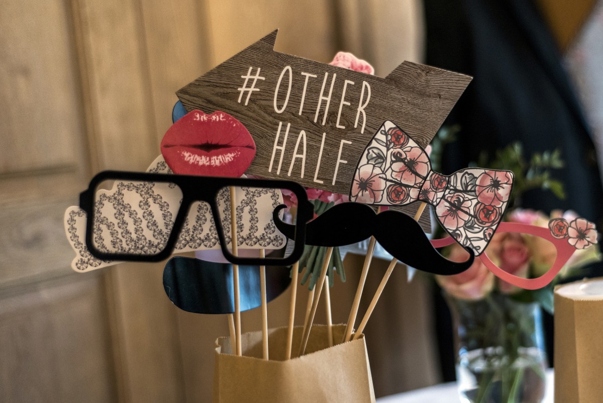Photo booth props including glasses, mustache and other fun cutouts