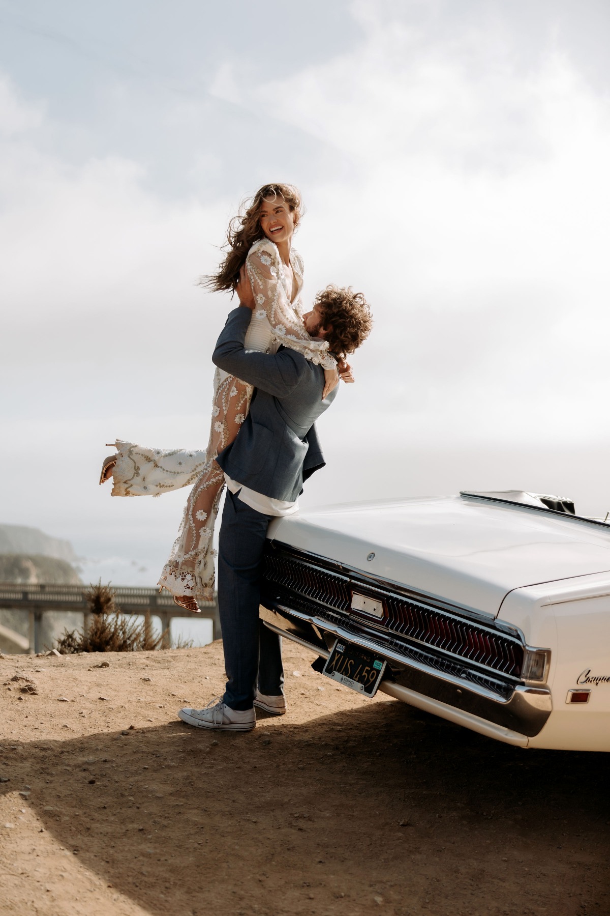 Happy couple celebrating their wedding day with classic car