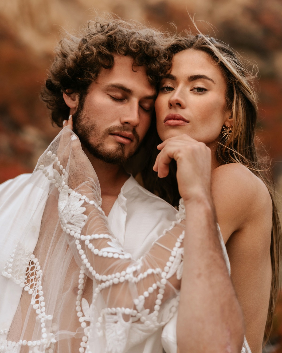 Romantic couple embracing tenderly outdoors, posing for a portrait