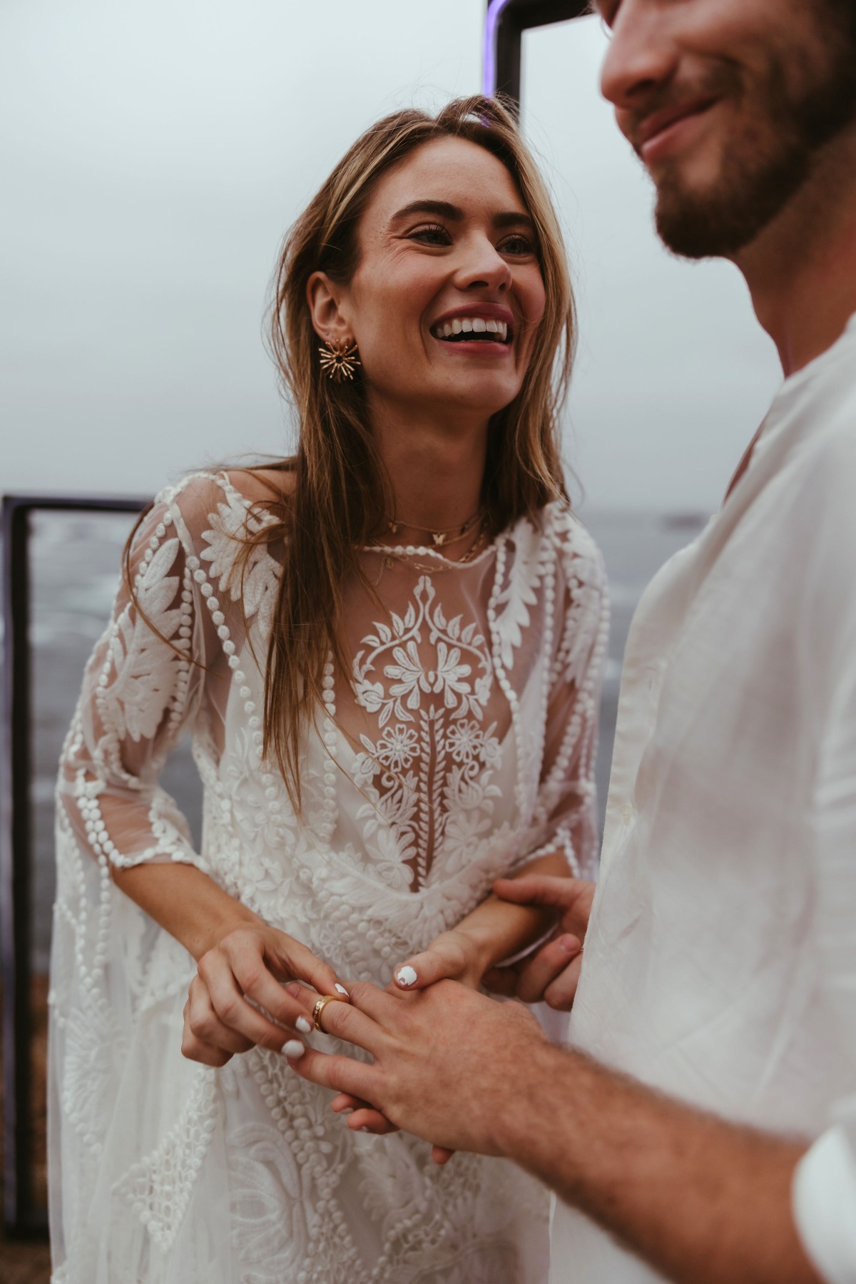 Bride placing ring on grooms finger during a wedding ceremony