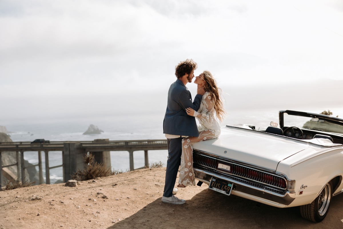 Couple in love on a road trip with vintage convertible car
