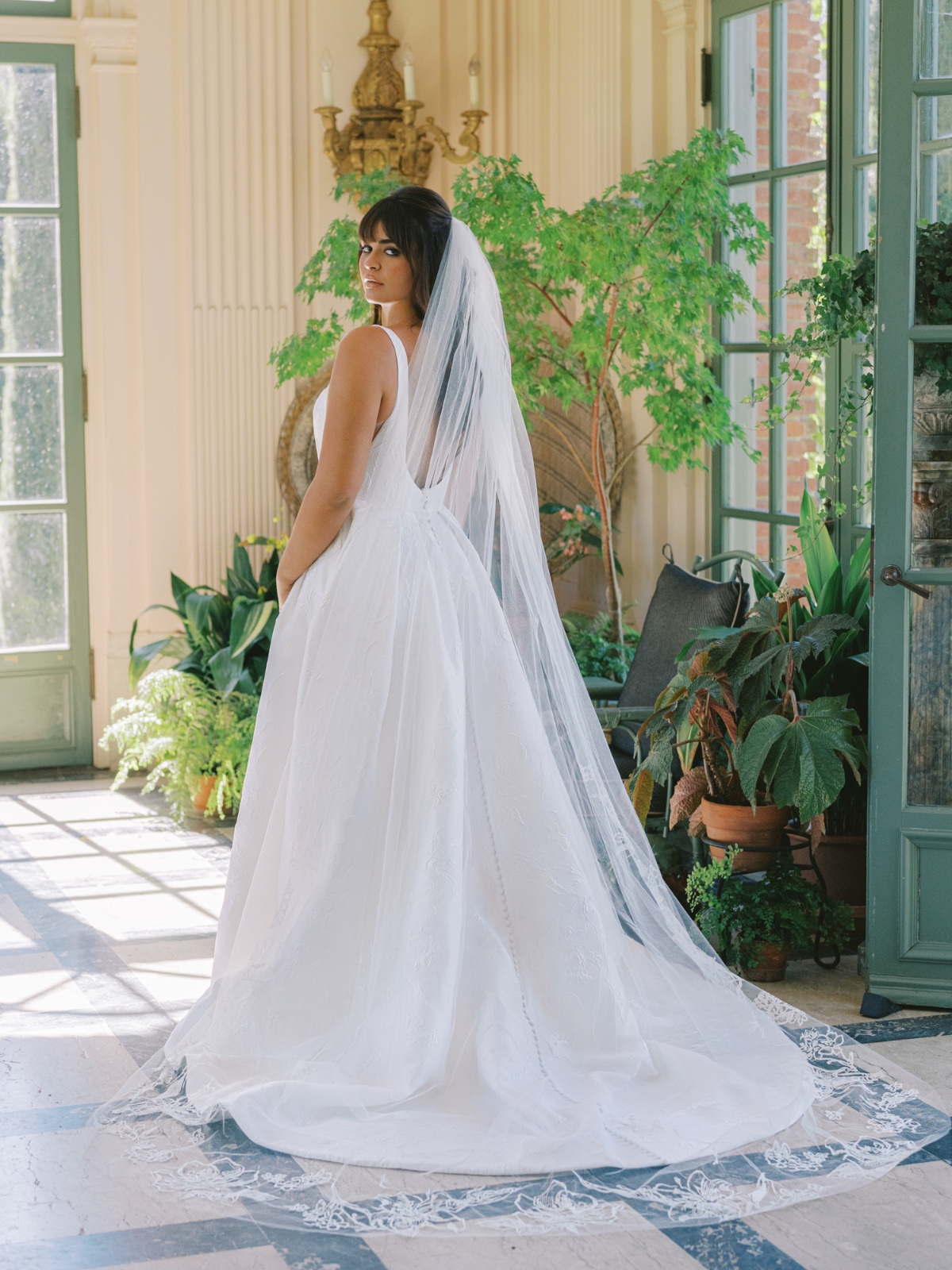 Elegant bride in a stunning wedding dress, looking over shoulder