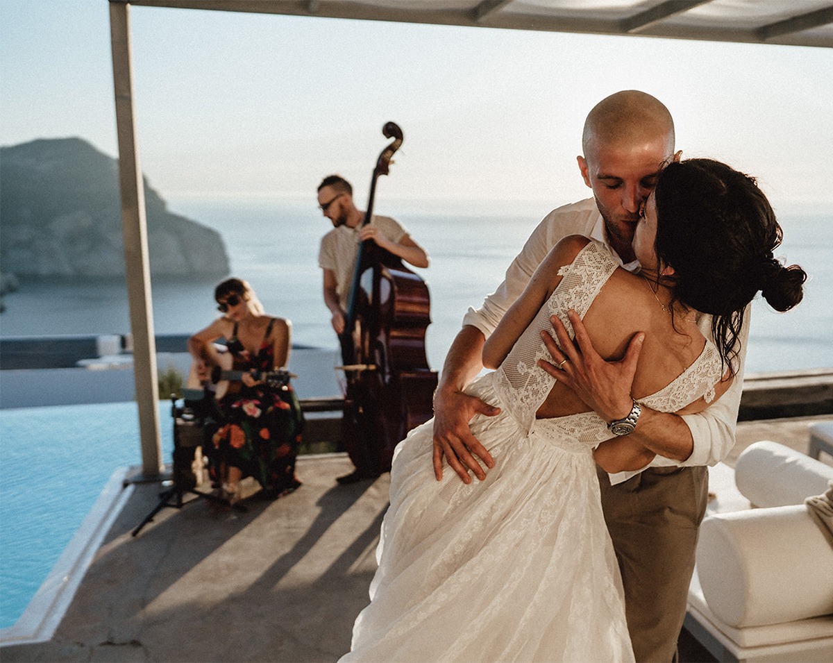 Wedding couple embraces with musicians playing background music