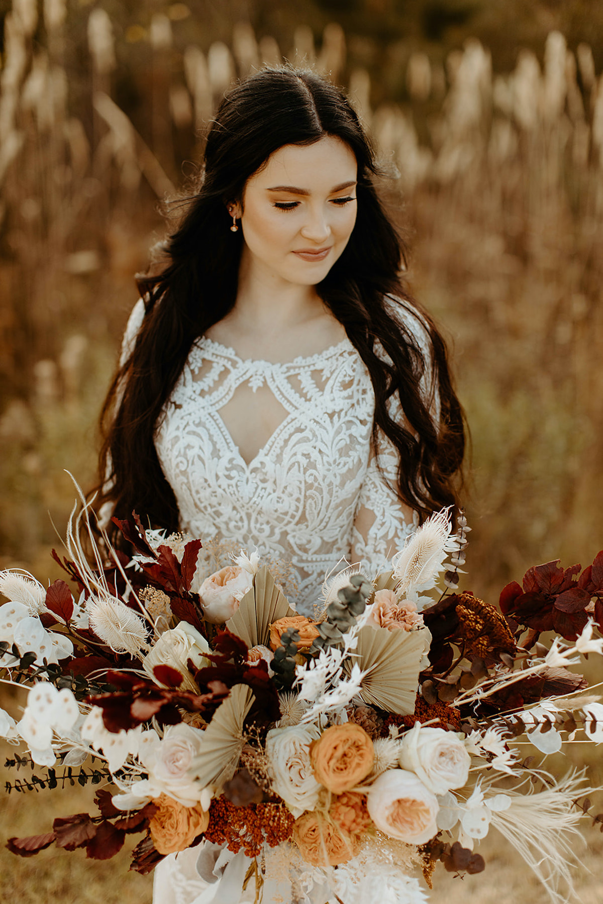 Elegant bride with beautiful bouquet and lace wedding dress