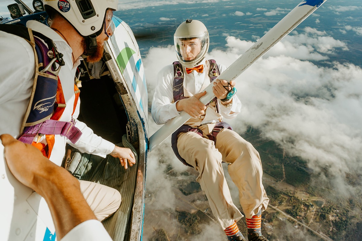 A man in a suit jumps out of a plane for a daring skydive