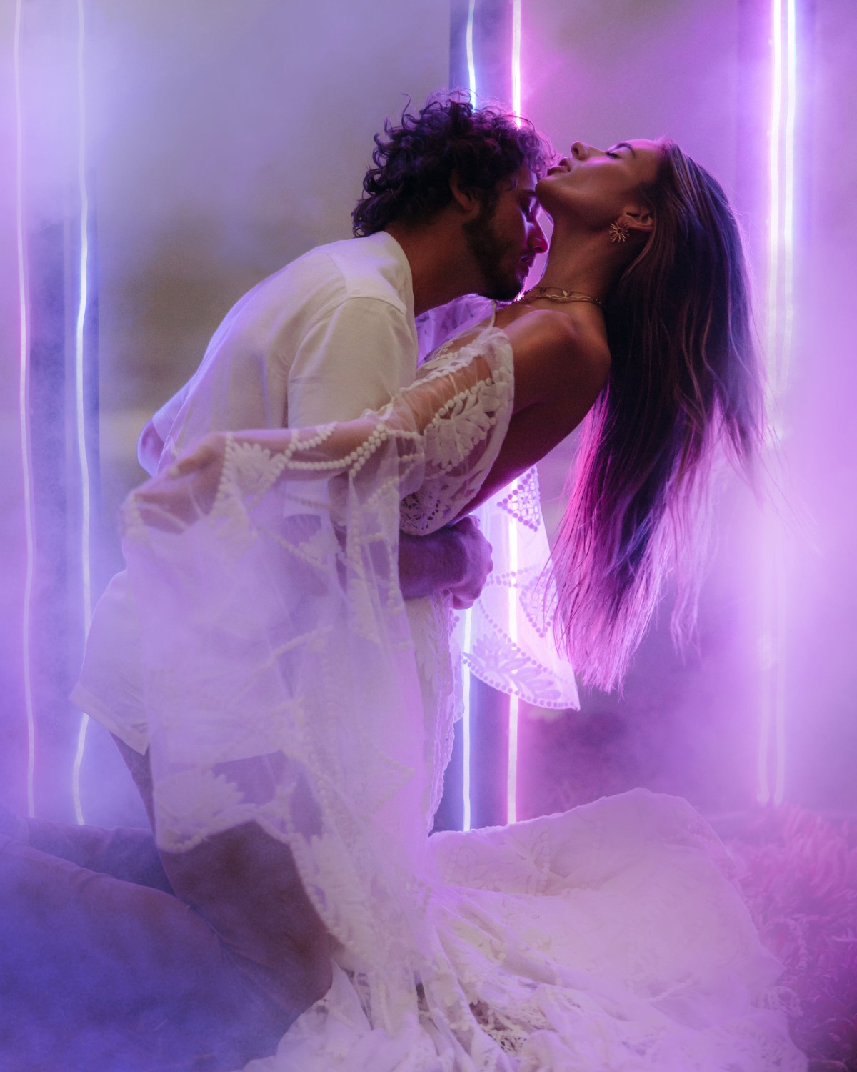 Romantic couple in a dreamy embrace under purple neon lights