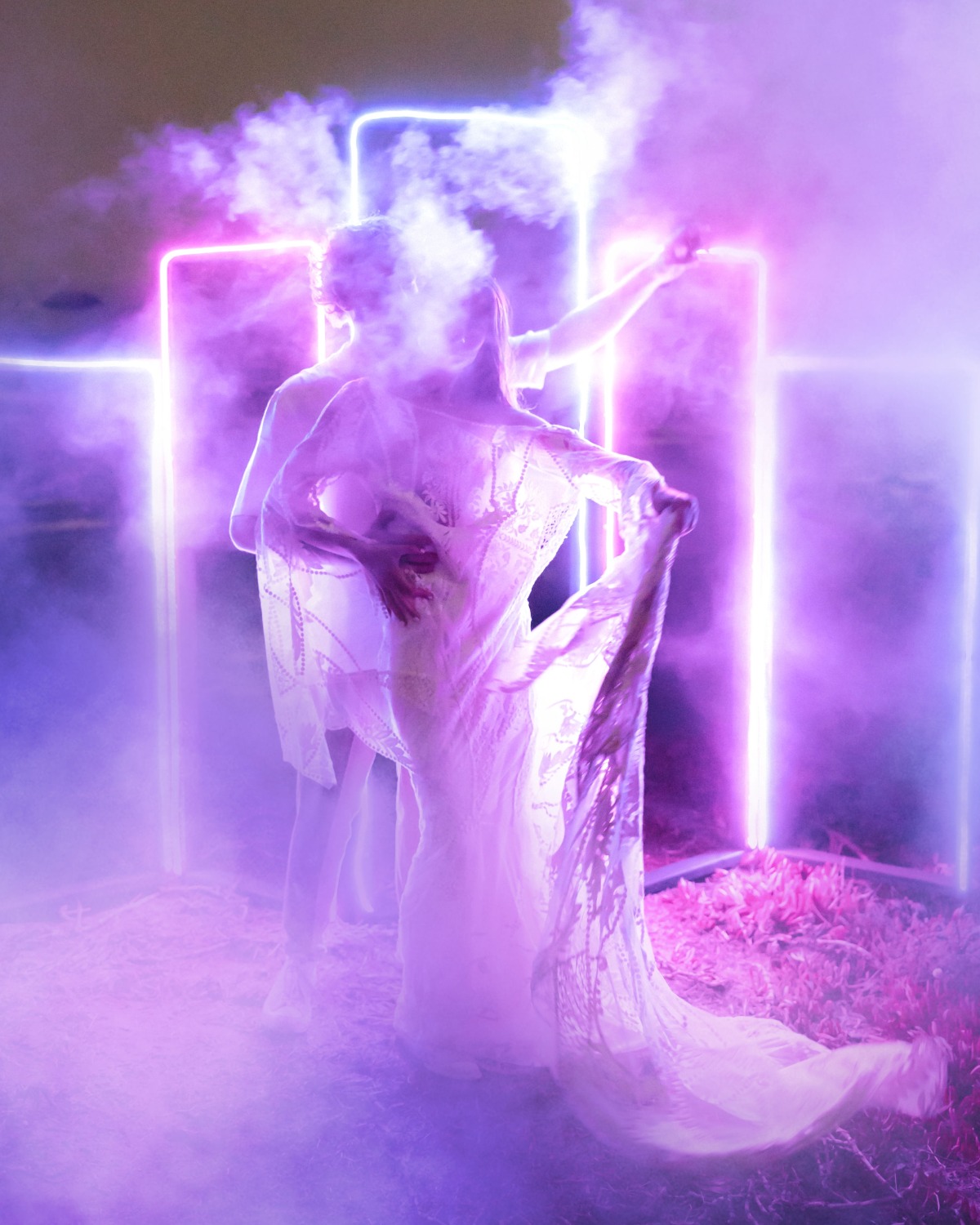Mystical figures dance in neon light and ethereal fog
