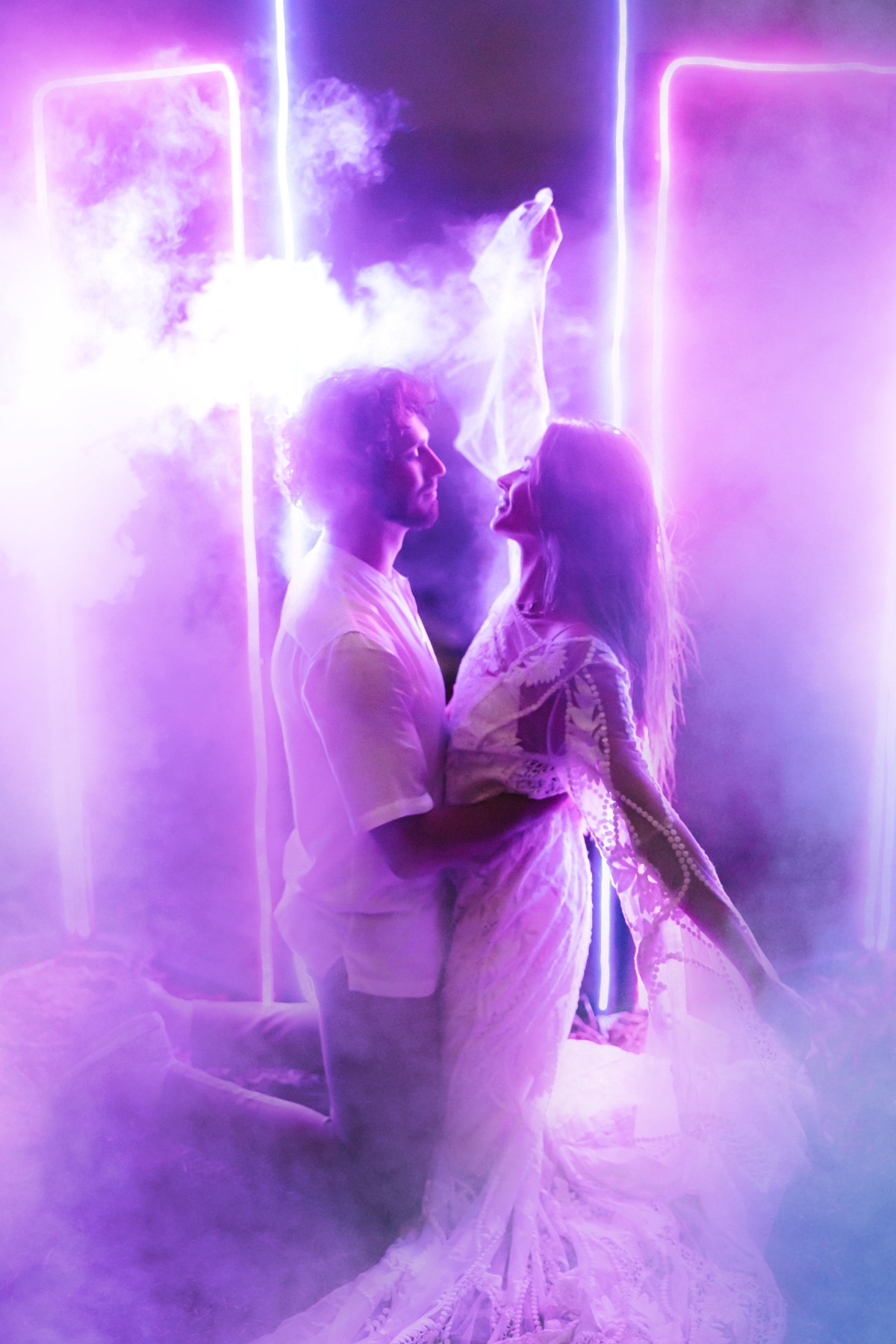Couple embracing under neon lights in a purple haze