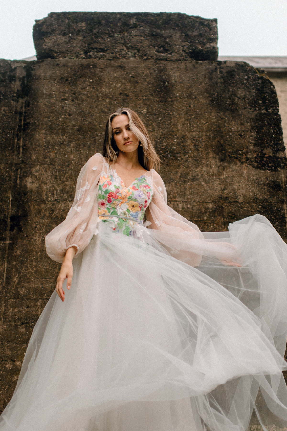Elegant woman in floral dress posing outdoors for a photoshoot