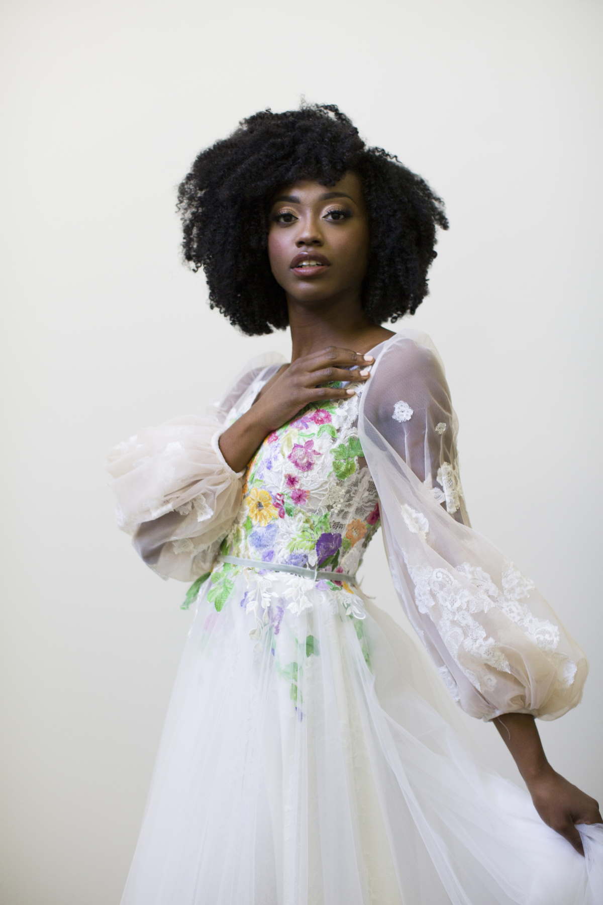 Beautiful woman in floral wedding dress, looking to the side