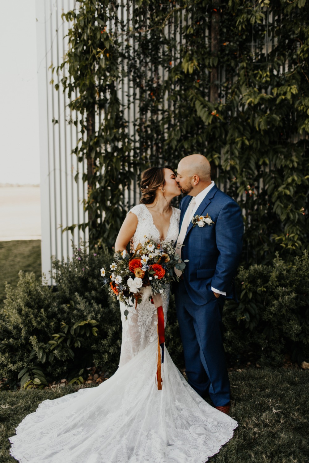 Newlyweds share a kiss on their wedding day, beautiful dress