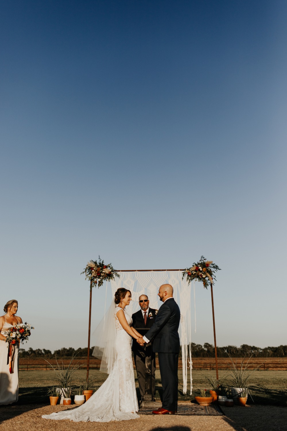 Happy couple exchanging vows in an outdoor wedding ceremony