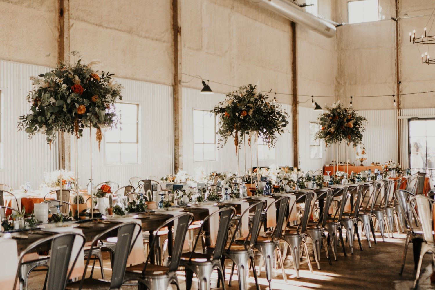 Elegant wedding reception table setting with floral centerpieces