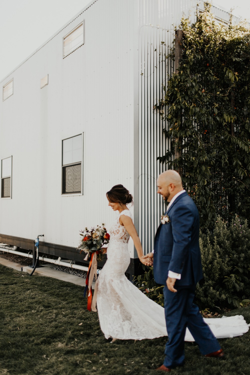 Bride and groom walking hand in hand after the wedding ceremony