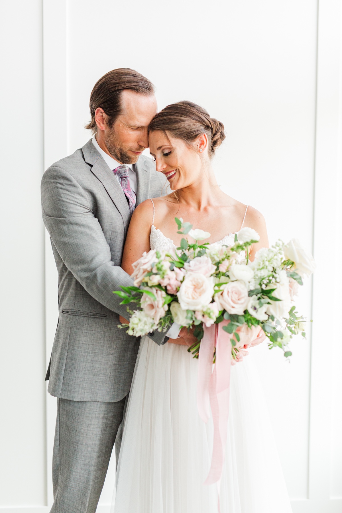 Happy bride and groom embracing on their wedding day
