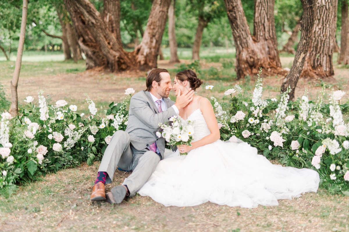 Romantic wedding couple in a field of flowers, happy together