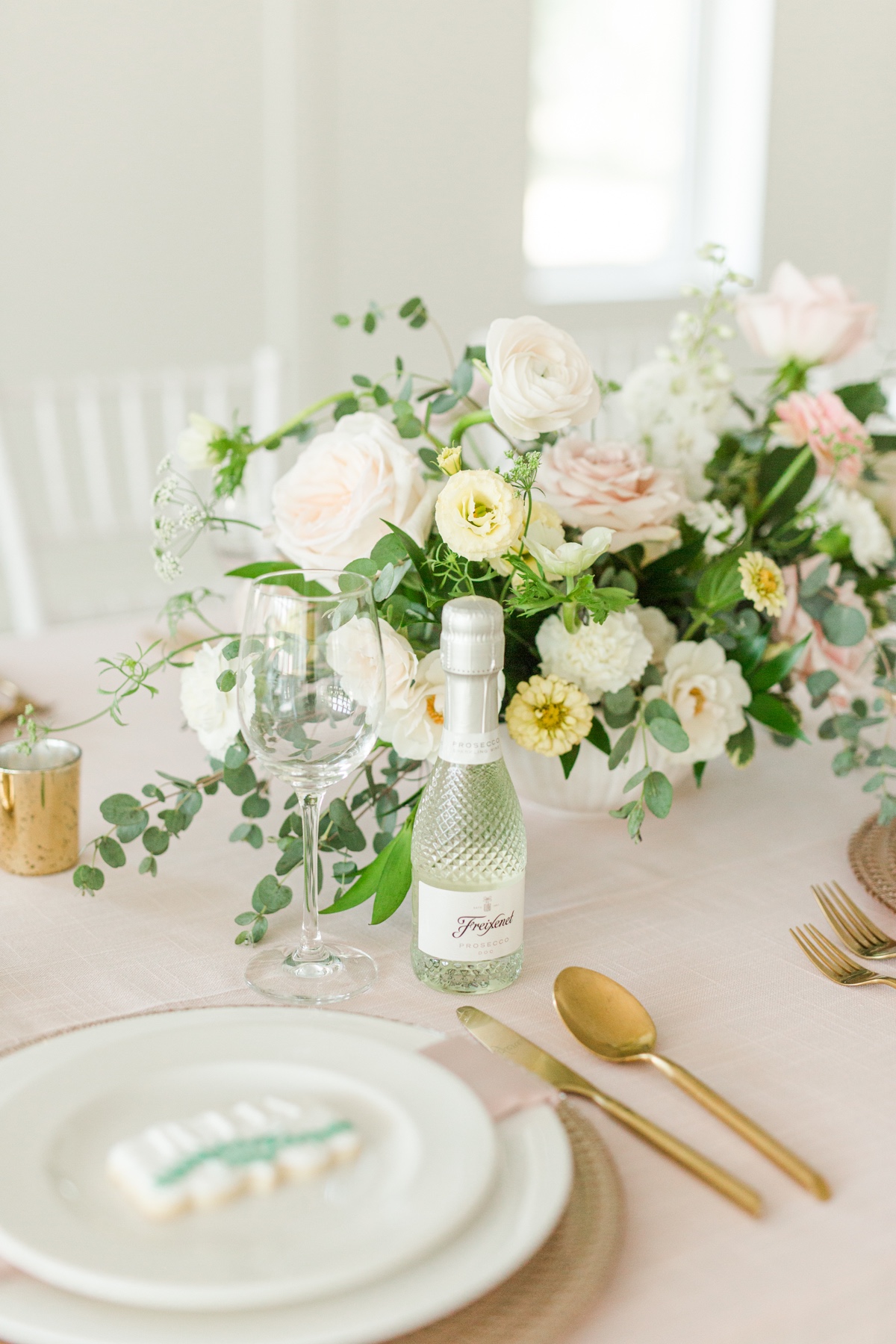 Elegant table setting with flowers and champagne bottle