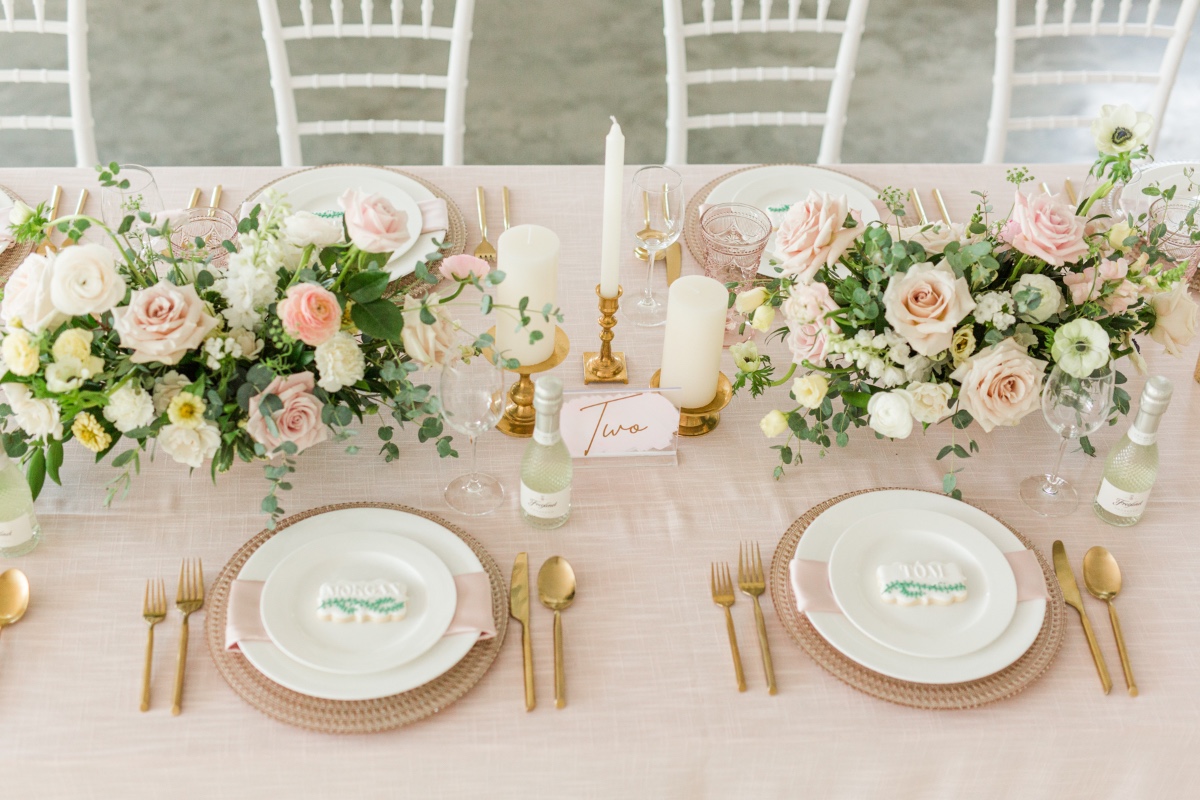 Elegant wedding table setting with floral arrangement and gold accents