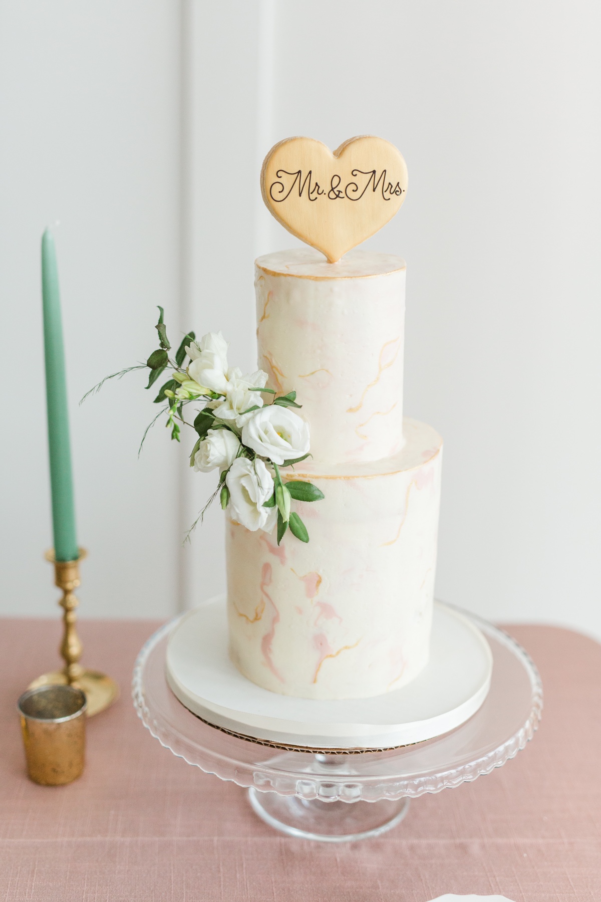 Elegant wedding cake with floral details and heart topper