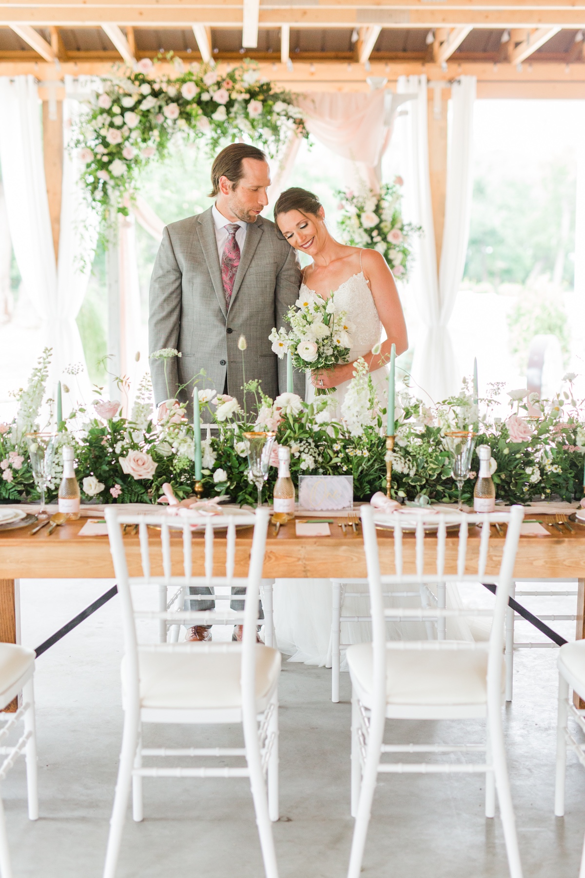Happy couple at wedding reception with flower decorations