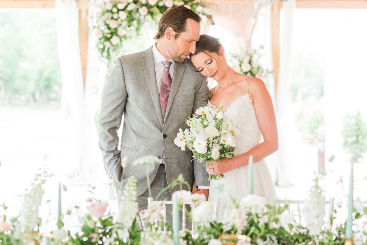 Newlyweds embrace tenderly at a beautifully decorated wedding