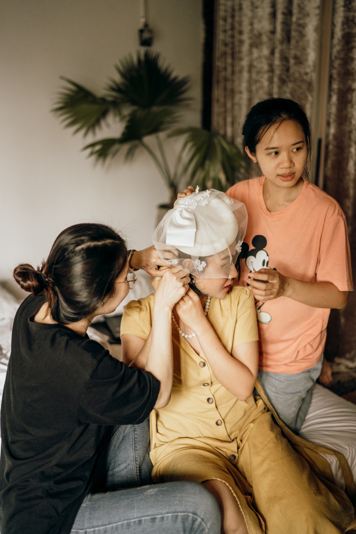 Bride gets ready with friends help before her wedding
