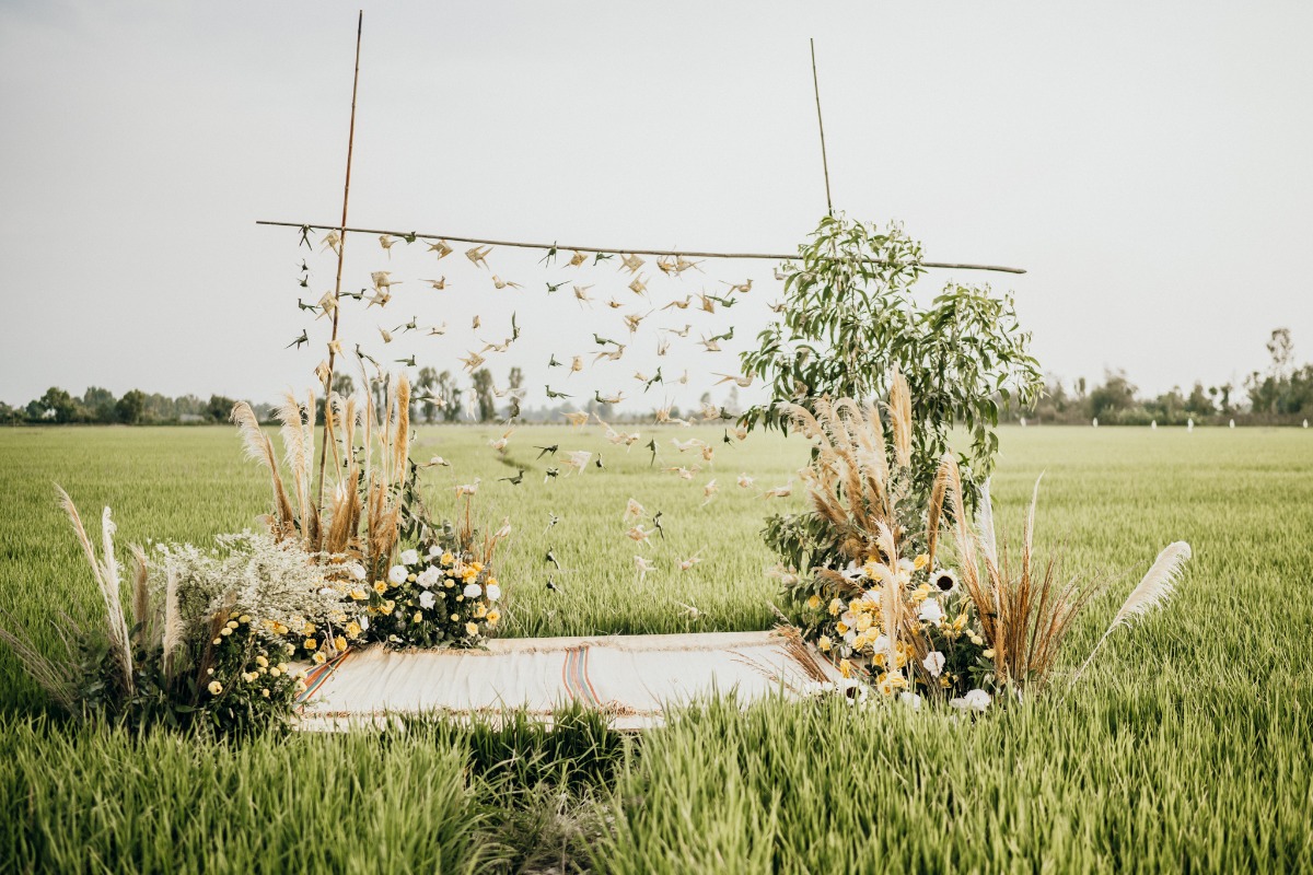 Wedding arch in rice field with pampas grass decor